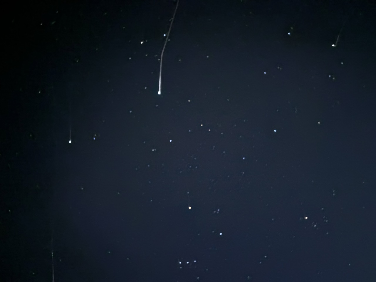 Photograph of a satellite light trail in the night sky